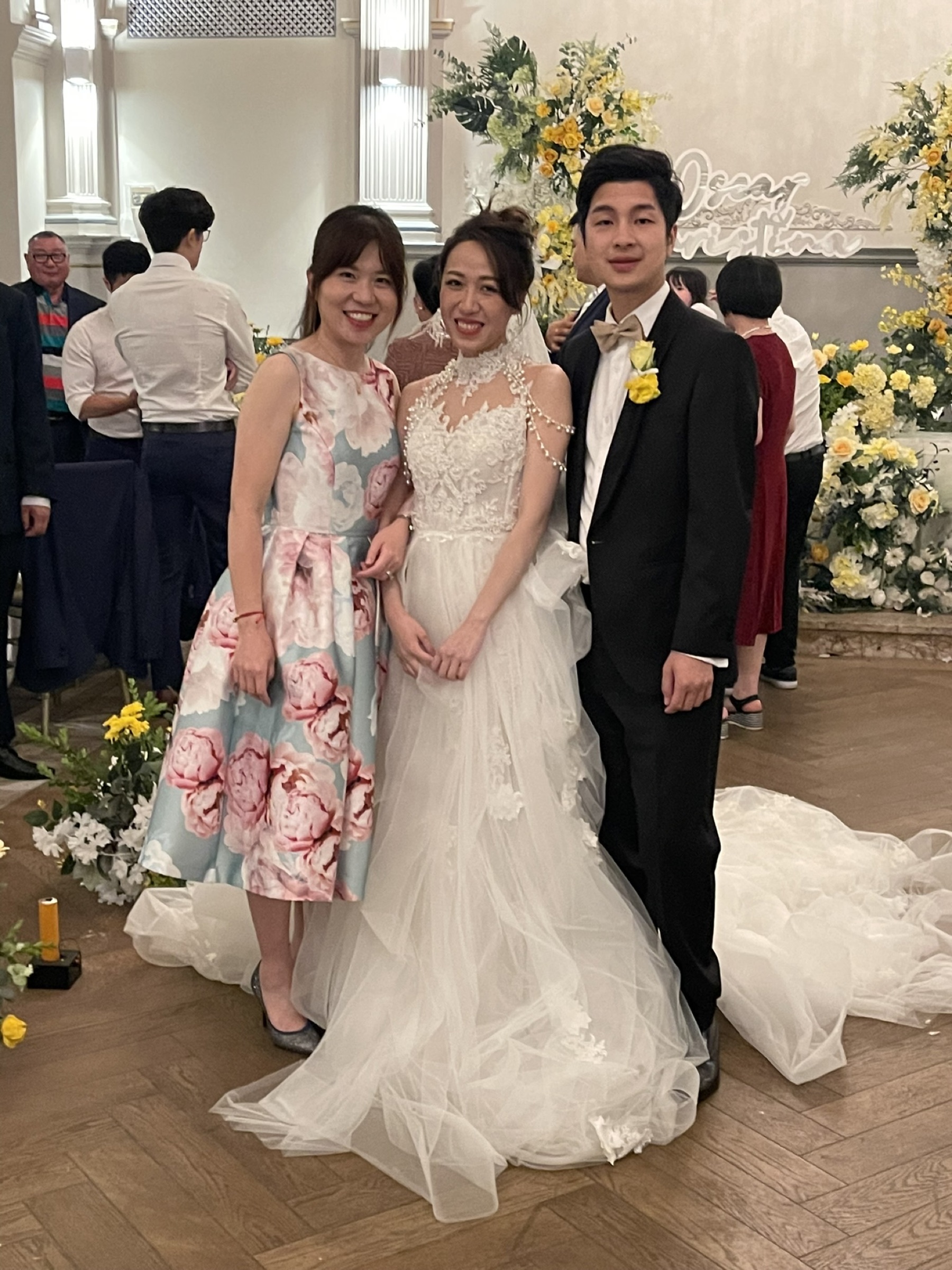 Violet Tang with a newly married couple at Curzon Hall in Sydney