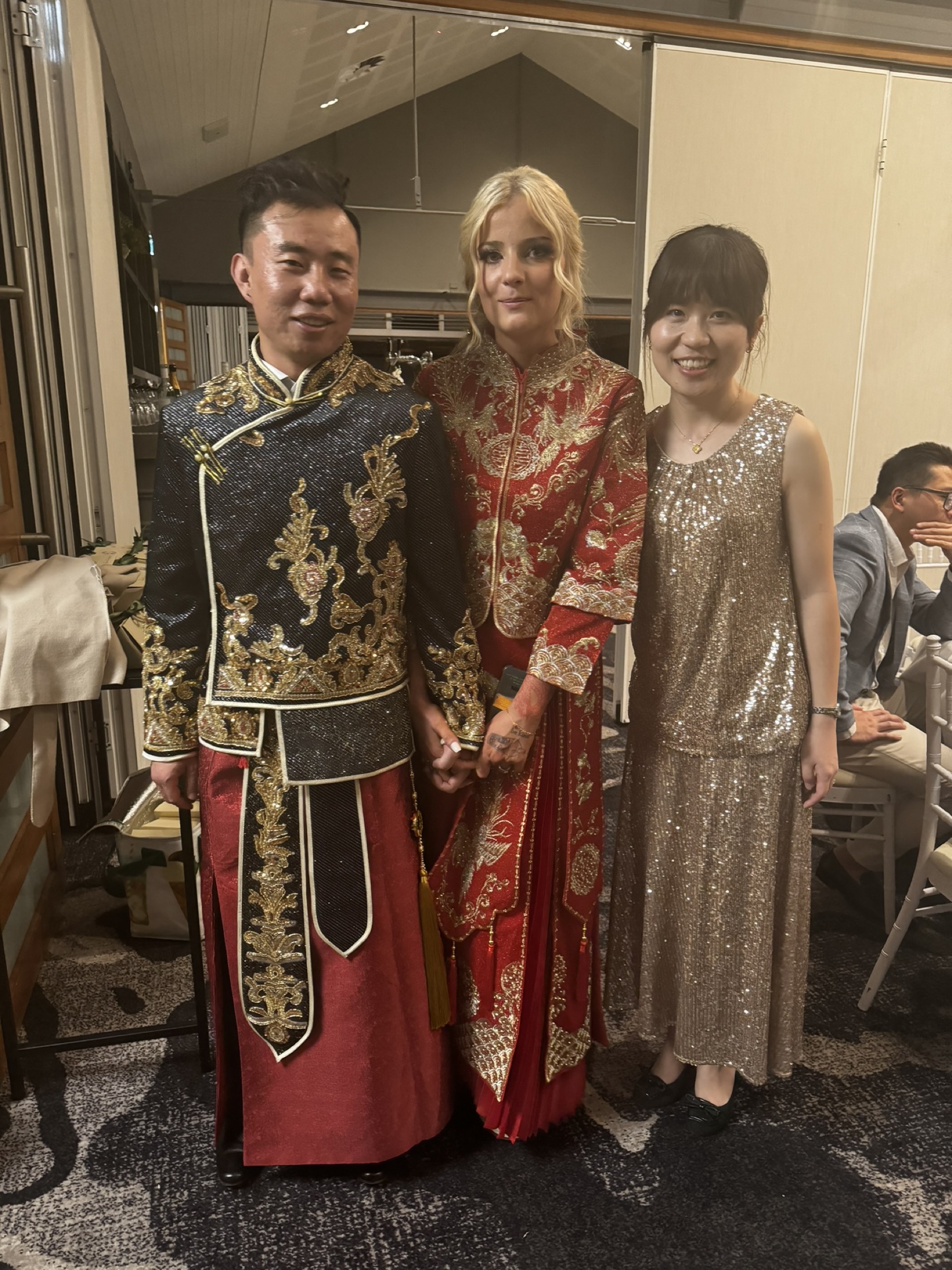 Couple in traditional Chinese wedding attire with Violet Tang at a tea ceremony